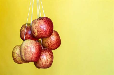 Apple suspended in an upward-moving elevator