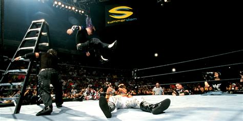 Jeff Hardy about to perform the Swanton Bomb on Spike Dudley and Rhyno in TLC II.