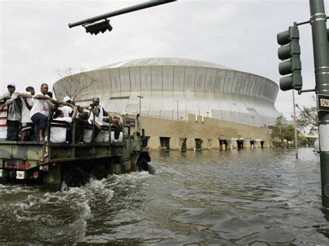 National Guard trucks haul residents through floodwaters
